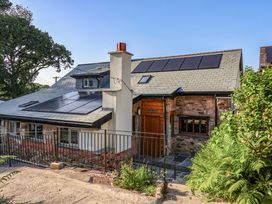 A house with solar panels and a chimney at Heathmoor in Horrabridge