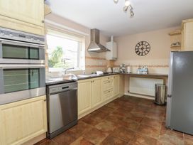 A kitchen with built-in oven dishwasher fridge and countertop appliances at White Lion Retreat in Cromer