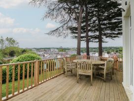 An outdoor seating area with a table and chairs at Fir Grove in Menai Bridge