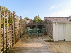 An outdoor seating area with a table and chairs at The Fir Grove Annex in Menai Bridge