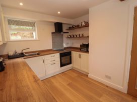A kitchen with a sink and oven at Bramble Cottage Thornthwaite near Braithwaite