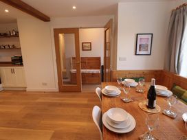 A dining room with table set for dinner at Bramble Cottage Thornthwaite near Braithwaite