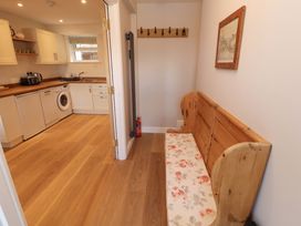 A kitchen with a bench and washing machine at Bramble Cottage Thornthwaite near Braithwaite