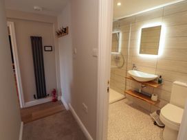 A bathroom with a sink and shower at Bramble Cottage Thornthwaite near Braithwaite