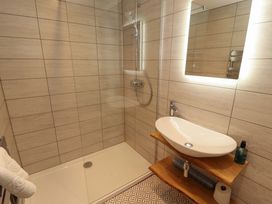 A bathroom with a shower and sink at Bramble Cottage in Thornthwaite near Braithwaite