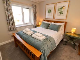 A bedroom with a bed and pillows at Bramble Cottage in Thornthwaite near Braithwaite