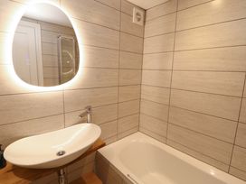 A bathroom with a sink and bath tub at Bramble Cottage Thornthwaite near Braithwaite