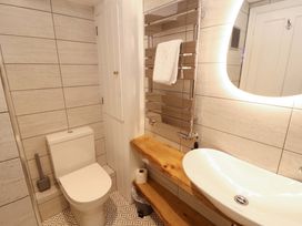 A bathroom with a toilet and sink at Bramble Cottage Thornthwaite near Braithwaite