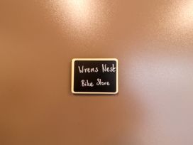 A sign that reads Wrens Nest Bike Store in a bike storage area at Bramble Cottage Thornthwaite near Braithwaite