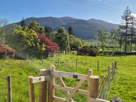 A scenic view with mountains and a gate at Bramble Cottage Thornthwaite near Braithwaite