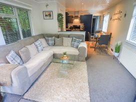 A living room with a sofa and coffee table at Evermore Lodge, 48 Calgarth Park, White Cross Bay, Windermere