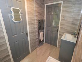 A bathroom with a sink and a shower at Evermore Lodge, 48 Calgarth Park, White Cross Bay, Windermere