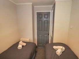 A bedroom with twin beds and towels at Evermore Lodge, 48 Calgarth Park, White Cross Bay, Windermere