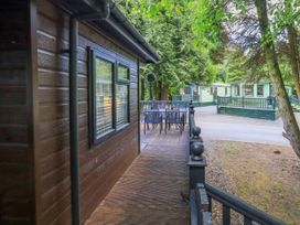 A patio area with a table and chairs at Evermore Lodge, 48 Calgarth Park, White Cross Bay, Windermere