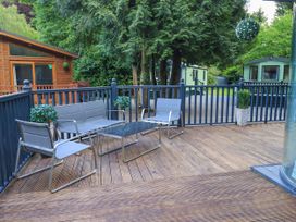 An outdoor seating area with chairs and table at Evermore Lodge, 48 Calgarth Park, White Cross Bay, Windermere