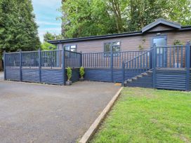 An outdoor view of a building with a railing and steps at Evermore Lodge, 48 Calgarth Park, White Cross Bay, Windermere