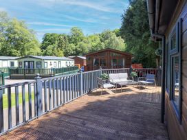 An outdoor seating area with a table at Evermore Lodge, 48 Calgarth Park, White Cross Bay, Windermere