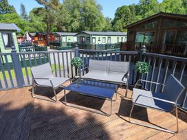 A seating area with chairs and a table at Evermore Lodge 48 Calgarth Park, White Cross Bay, Windermere