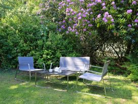 A garden with seating and a table at Evermore Lodge, 48 Calgarth Park, White Cross Bay, Windermere