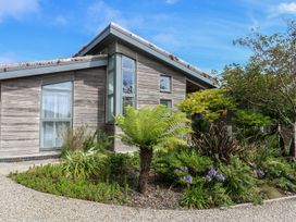 A house with large windows and a garden at Una, Lodge 70 Carbis Bay