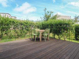 An outdoor area with a table and chairs at Una, Lodge 70, Carbis Bay