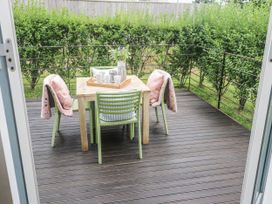 A table and chairs on a patio at Una, Lodge 70, Carbis Bay