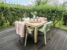 A table with chairs and coffee items at Una, Lodge 70, Carbis Bay