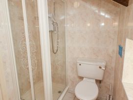 A bathroom with a shower enclosure and a toilet at Primula Patch in Akeld near Wooler