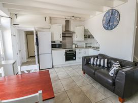 A kitchen with appliances and seating at Brynmorfa in Llandysul