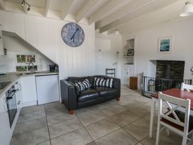 A living room with a couch and dining table at Brynmorfa in Llandysul