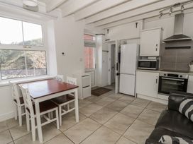 A kitchen with a table and chairs at Brynmorfa in Llandysul