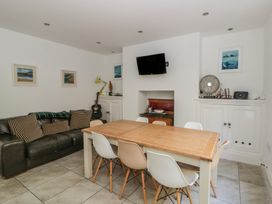 A dining room with a table and chairs at Brynmorfa in Llandysul