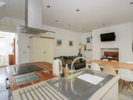 A kitchen with a dining area and appliances at Brynmorfa in Llandysul
