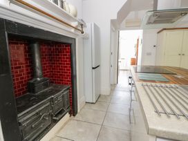 A kitchen with a stove and refrigerator at Brynmorfa in Llandysul