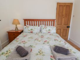 A bedroom with a bed and bedside table at Brynmorfa in Llandysul