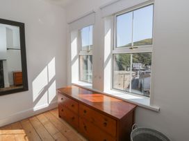 A bedroom with a dresser and windows at Brynmorfa in Llandysul