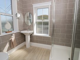 A bathroom with a sink and shower at Brynmorfa in Llandysul