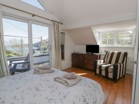 A bedroom with a bed and television at Brynmorfa in Llandysul