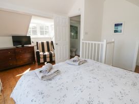 A bedroom with a bed and television at Brynmorfa in Llandysul