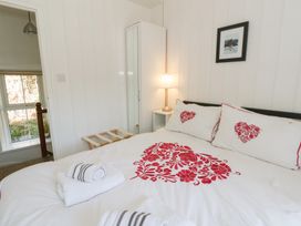 A bedroom with a bed and lamp at Brynmorfa in Llandysul