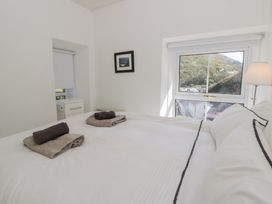A bedroom with a bed and window at Brynmorfa in Llandysul