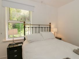 A bedroom with a bed and nightstand at Brynmorfa Llandysul