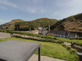 A view of mountains and houses from a patio at Brynmorfa in Llandysul