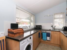 A kitchen with appliances and a window at Scarba in Oban