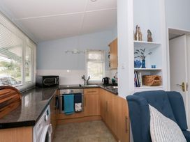A kitchen with appliances and furniture at Scarba in Oban