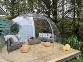 An outdoor seating area with a transparent dome and seating at Scarba in Oban