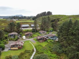 An outdoor area with cabins and trees at Scarba, Balvicar, Isle Of Seil