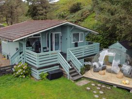 A house with a deck and seating area at Scarba in Balvicar, Isle Of Seil