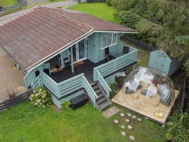 A house with a deck and outdoor furniture at Scarba Balvicar, Isle Of Seil