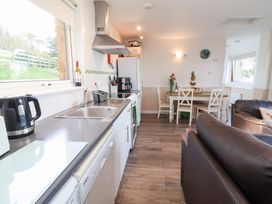 A kitchen with a dining area and seating at Castle View Lodge in Ilfracombe